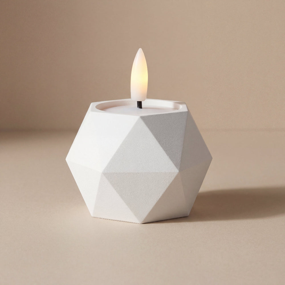 GEOMETRIC vendbar lysestage i hvid med LED fyrfadslys – skulpturel dansk design med facetteret geometrisk form.